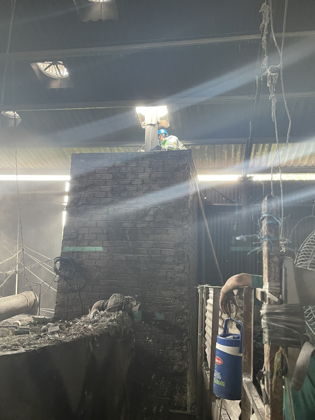 Công nhân tại cơ sở này đang đổ hạt nhựa vào máy nghiền Công nhân tại cơ sở này đang đổ hạt nhựa vào máy nghiền