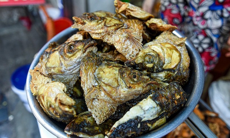 Đầu cá được chiên khéo léo trên chảo dầu nóng tới khi bên ngoài vàng giòn, bên trong mềm cả xương.